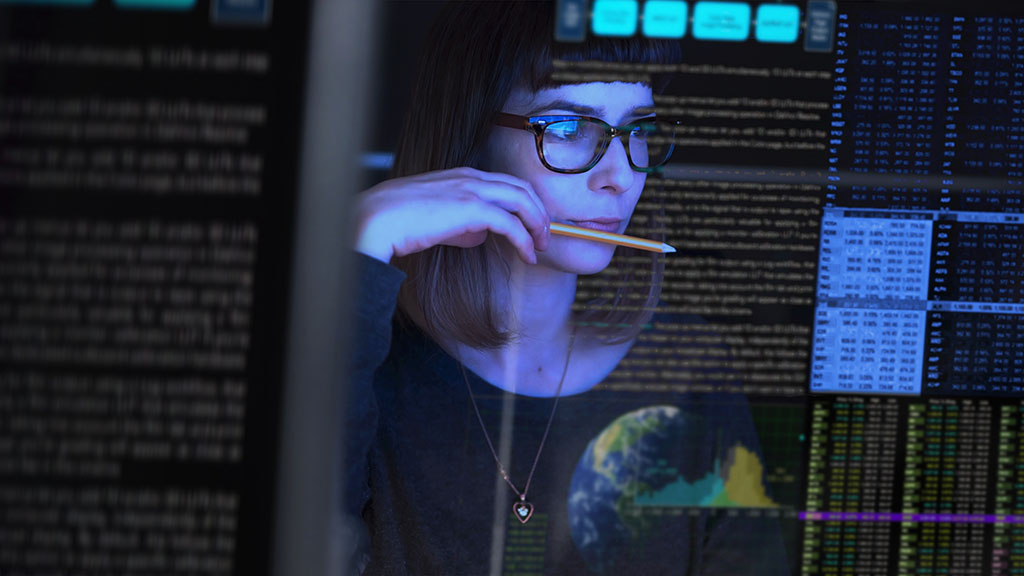 Stock image of a woman studying a see through computer screen powered by disaggregated storage
